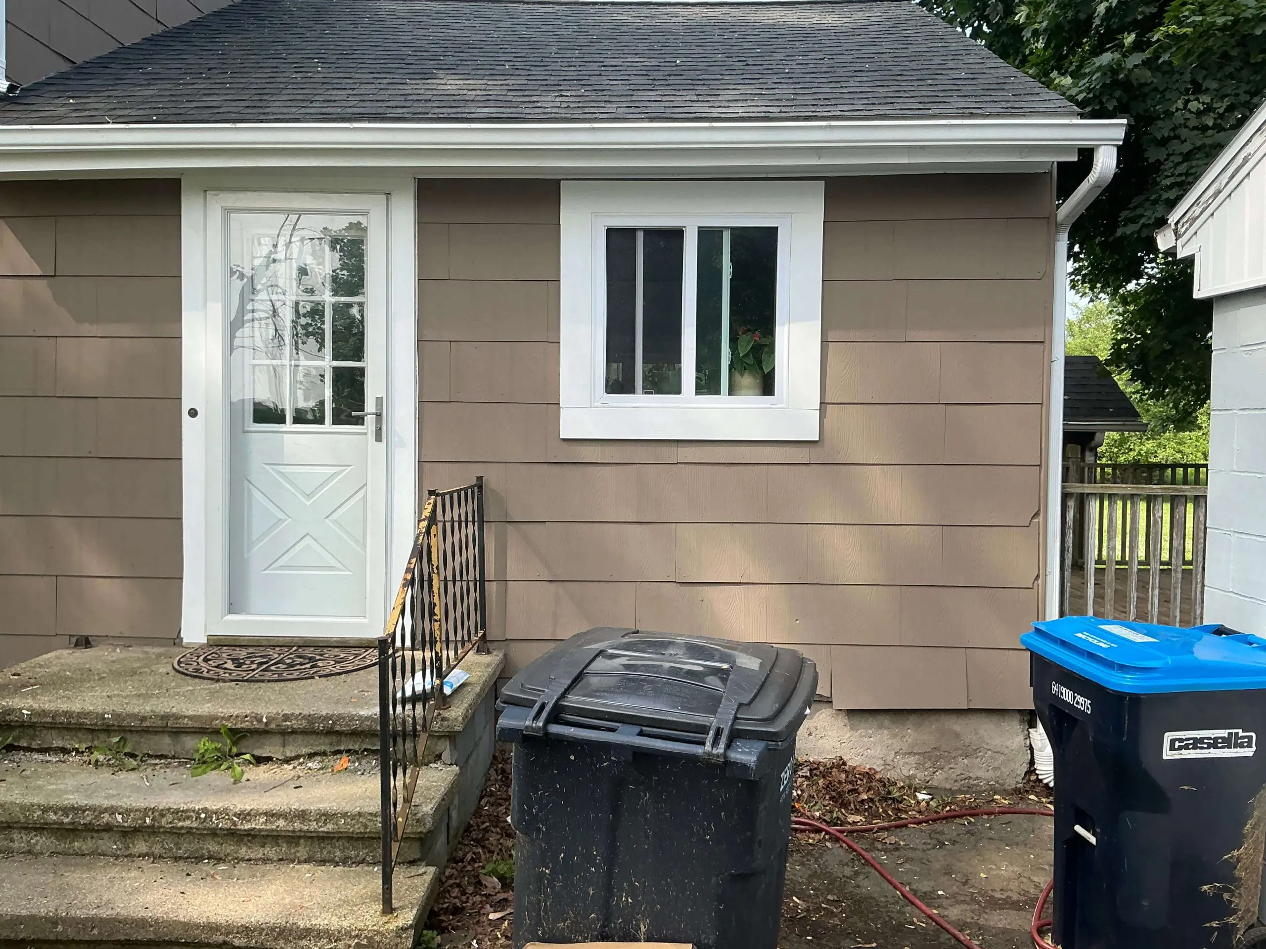 single story Buffalo house painted light tan exterior