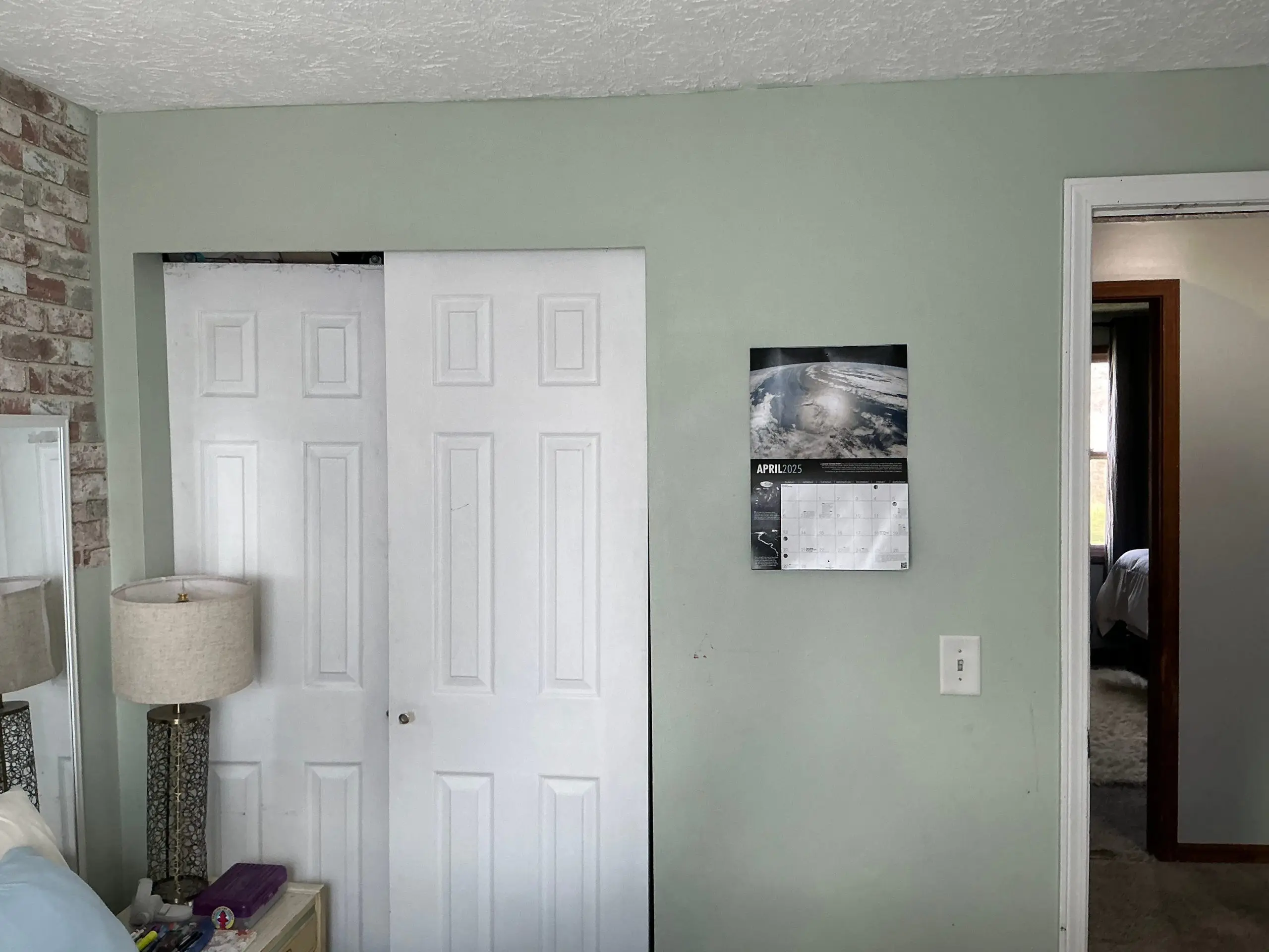 bedroom walls painted light green in Rochester home