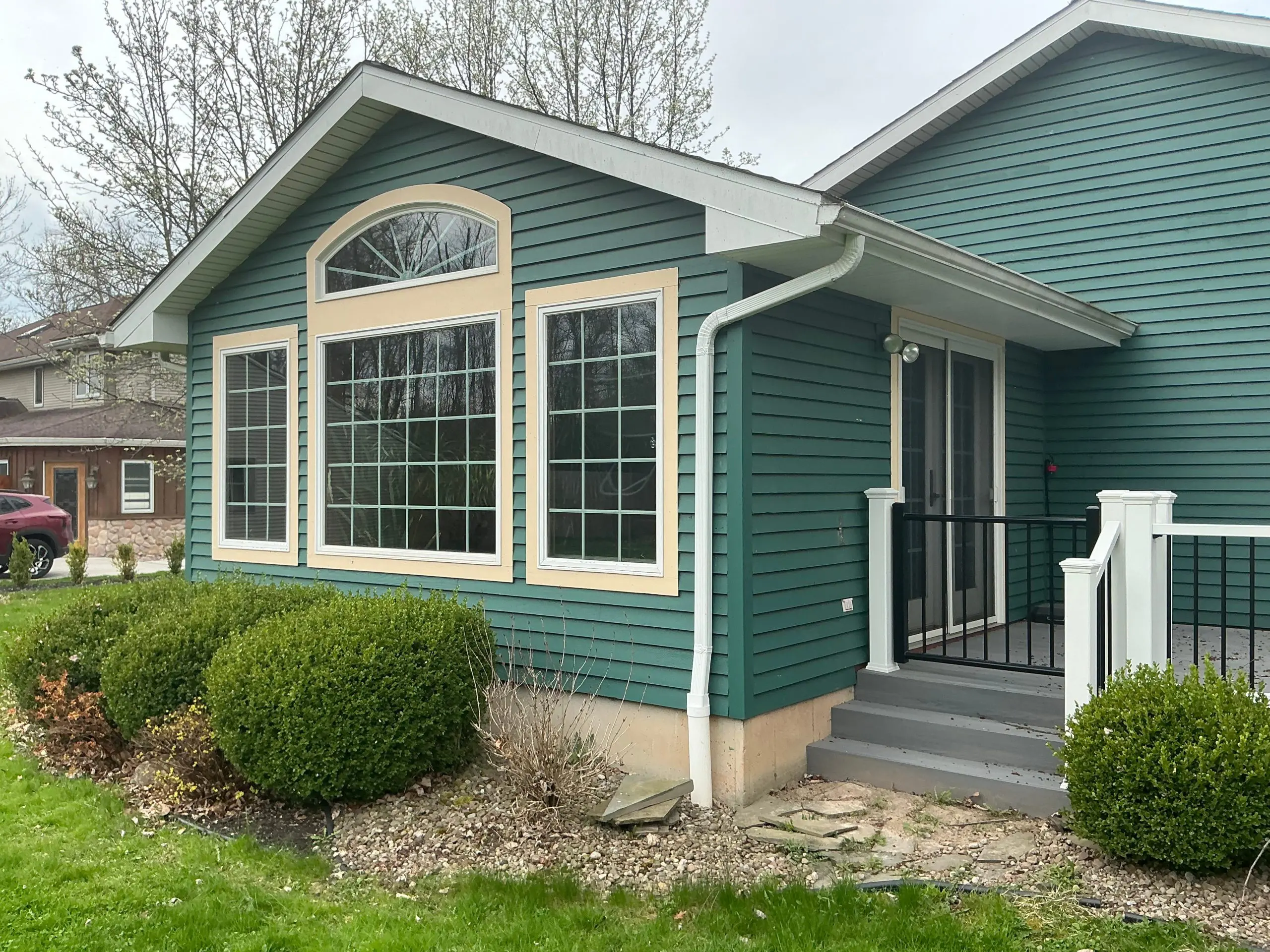 residential Buffalo house painted modern green
