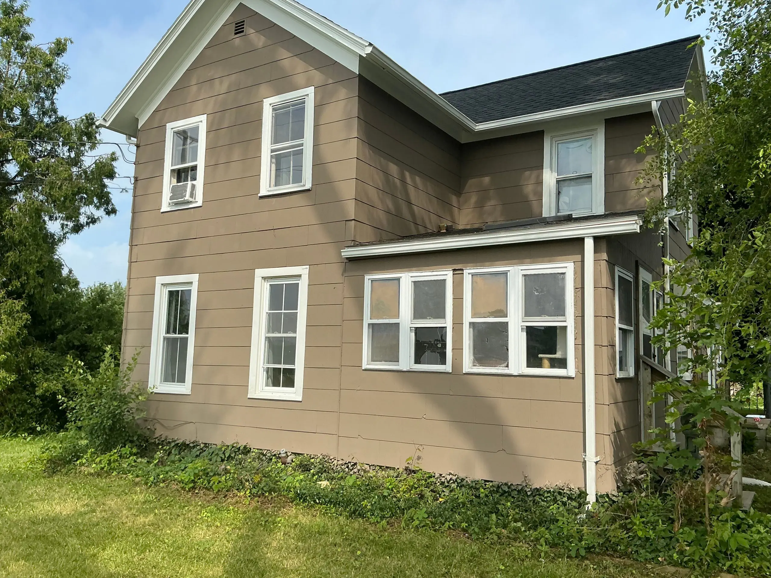 two story Buffalo house painted light tan exterior