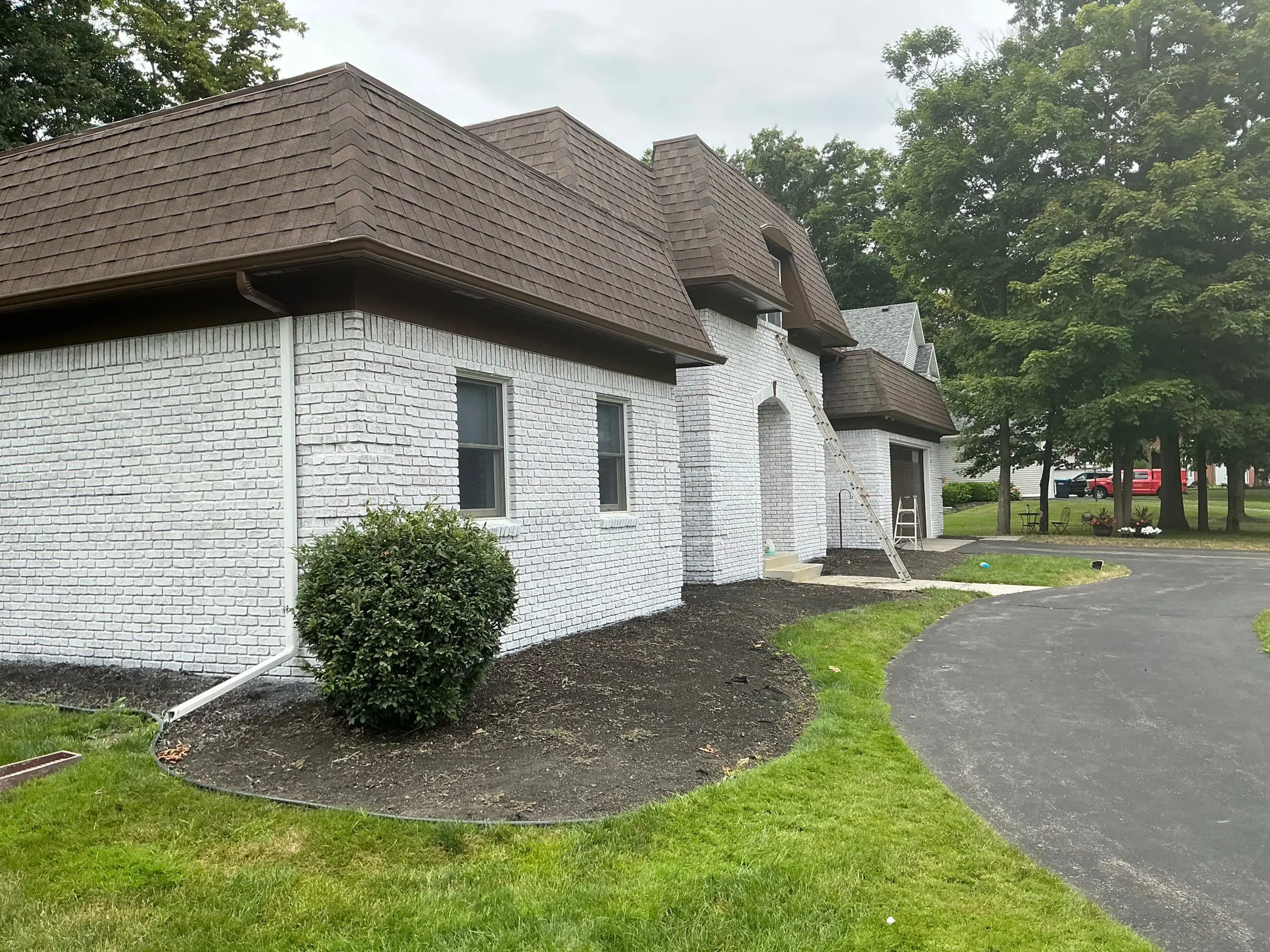 residential Buffalo house brick painting and stained white