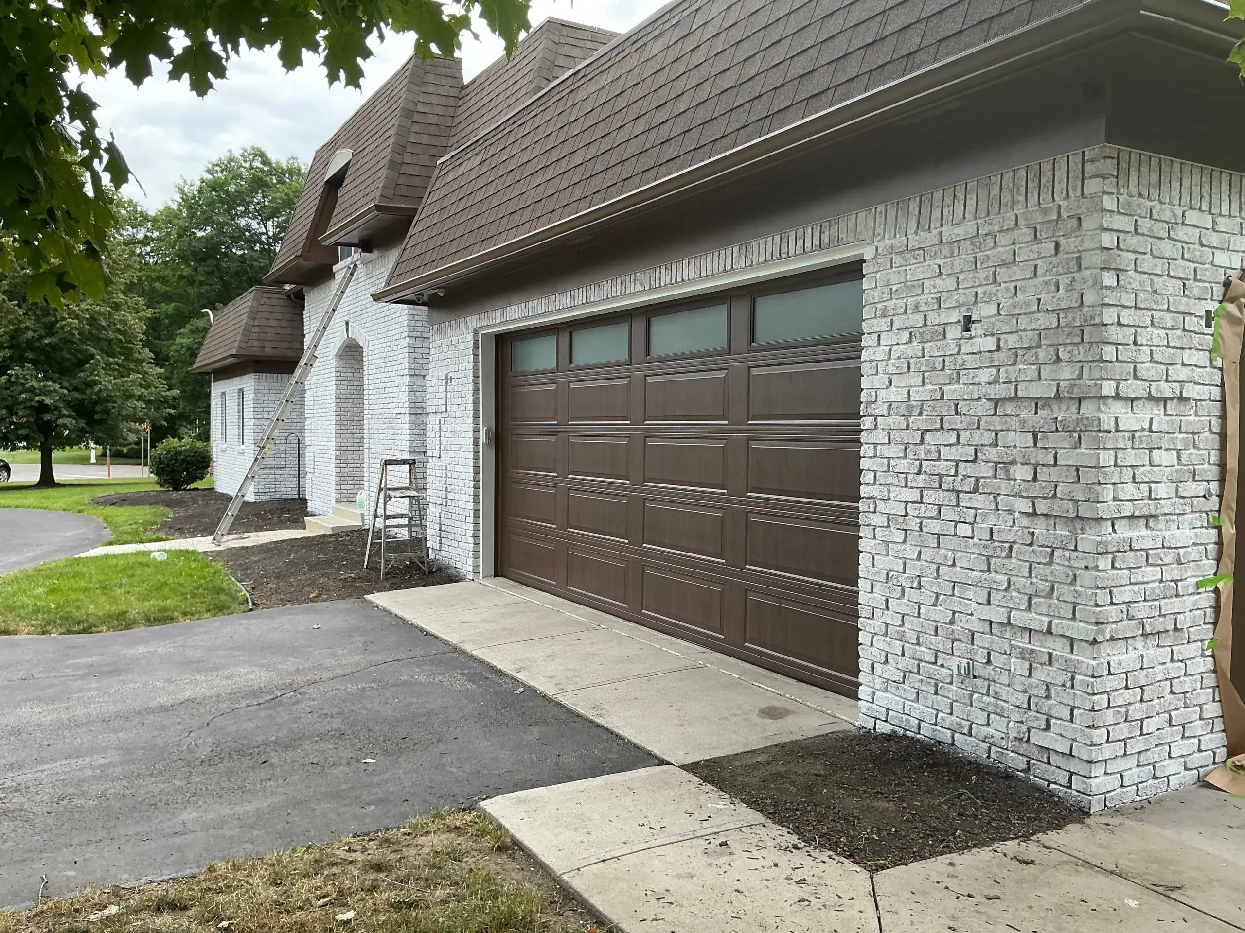 residential Buffalo house brick painting and stained white
