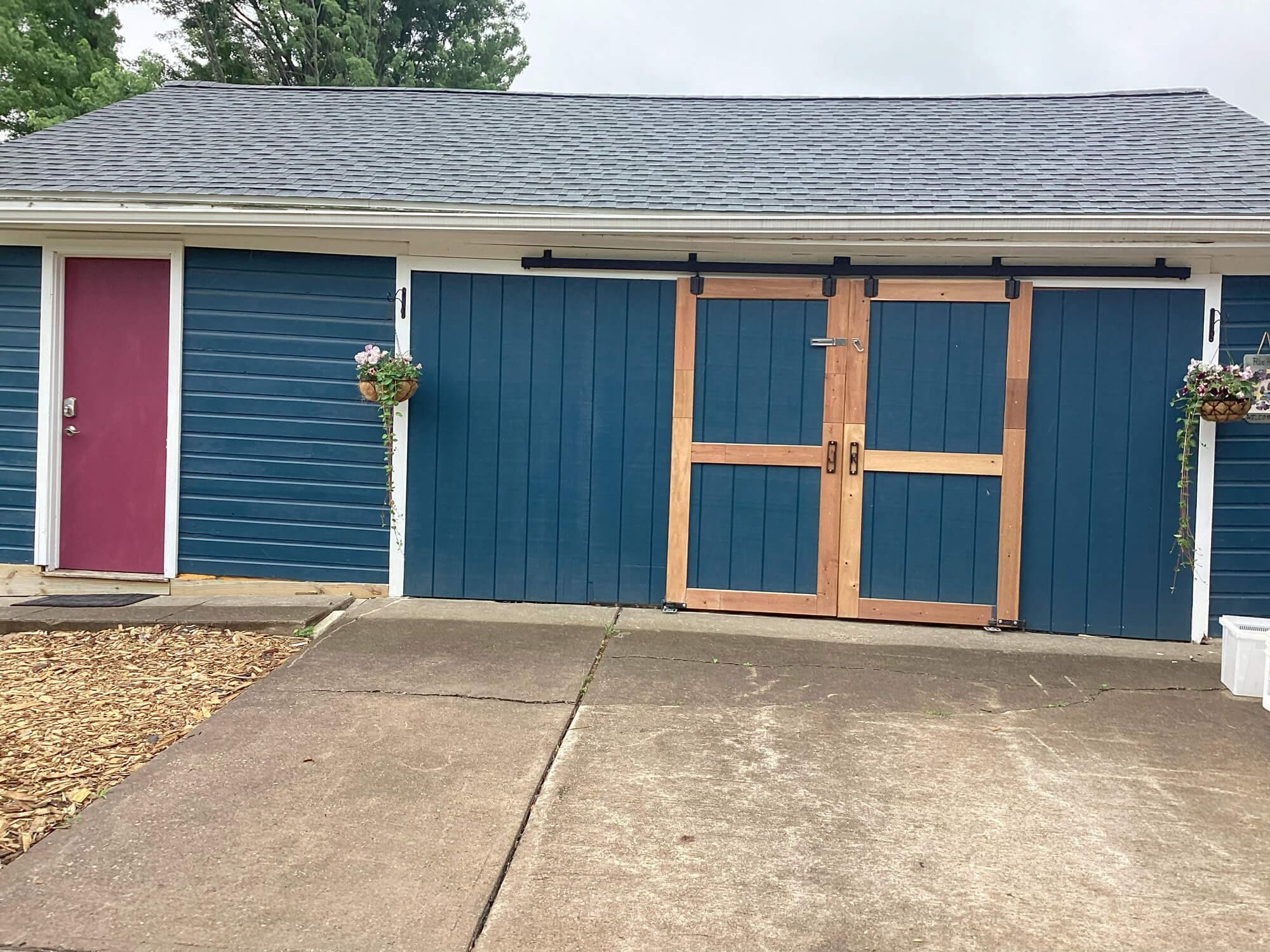a blue small house professionally repainted