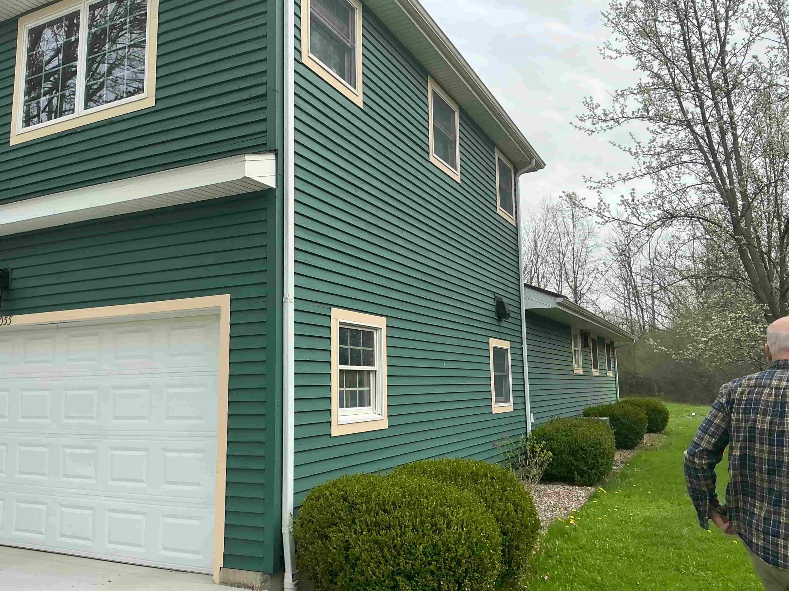 residential Buffalo house painted modern green