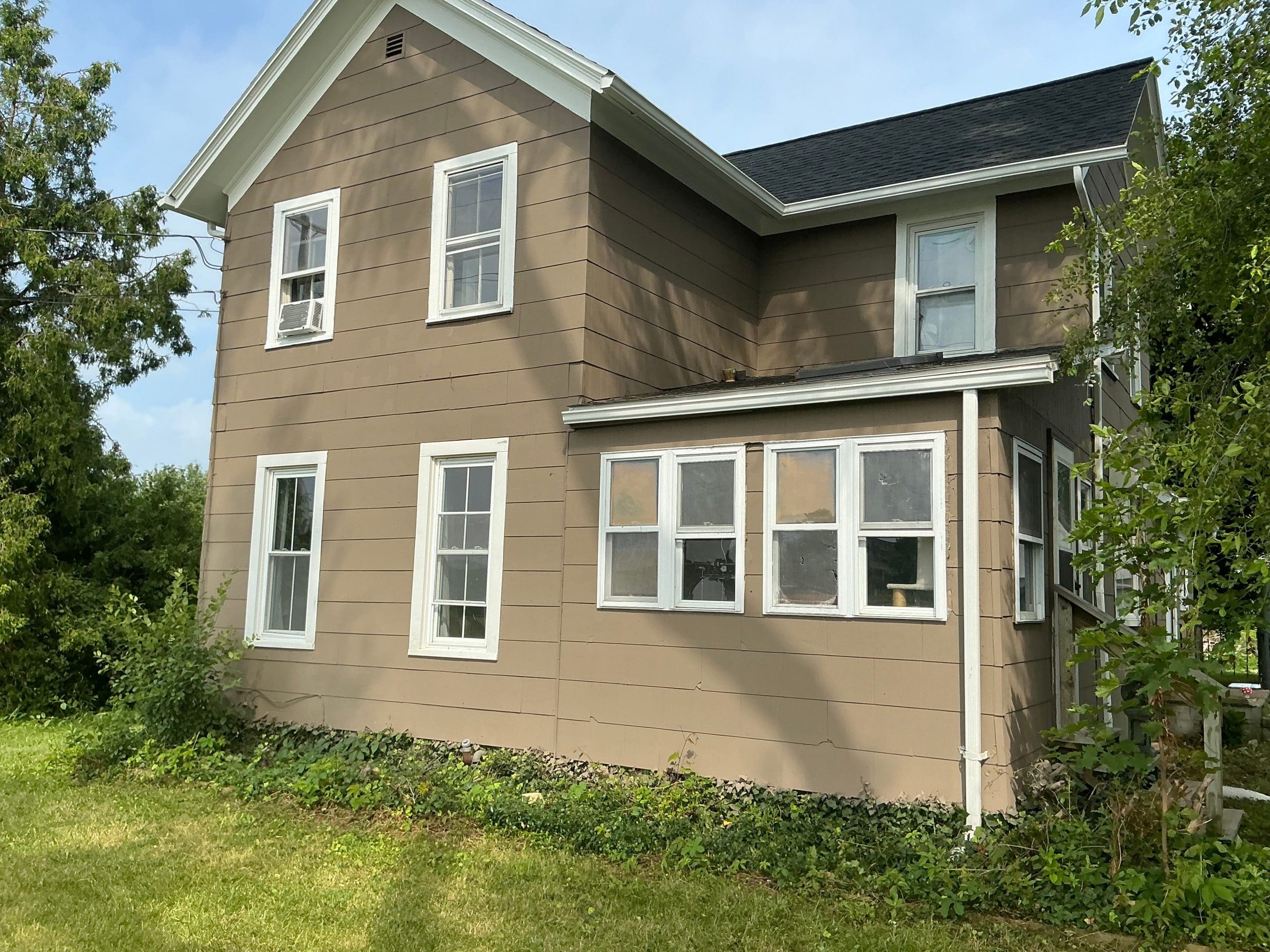 two story Buffalo house painted light tan exterior