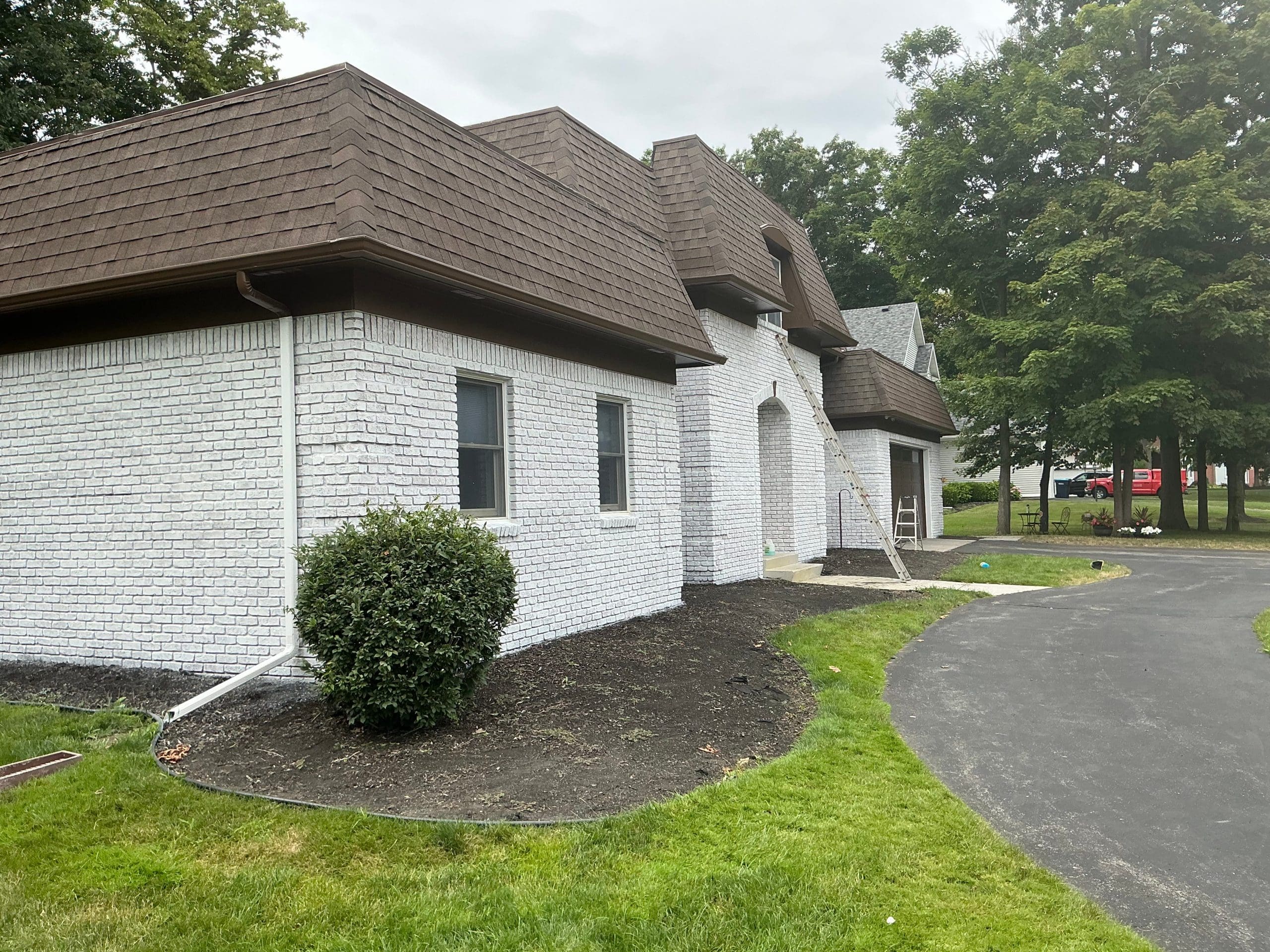 residential Buffalo house brick painting and stained white